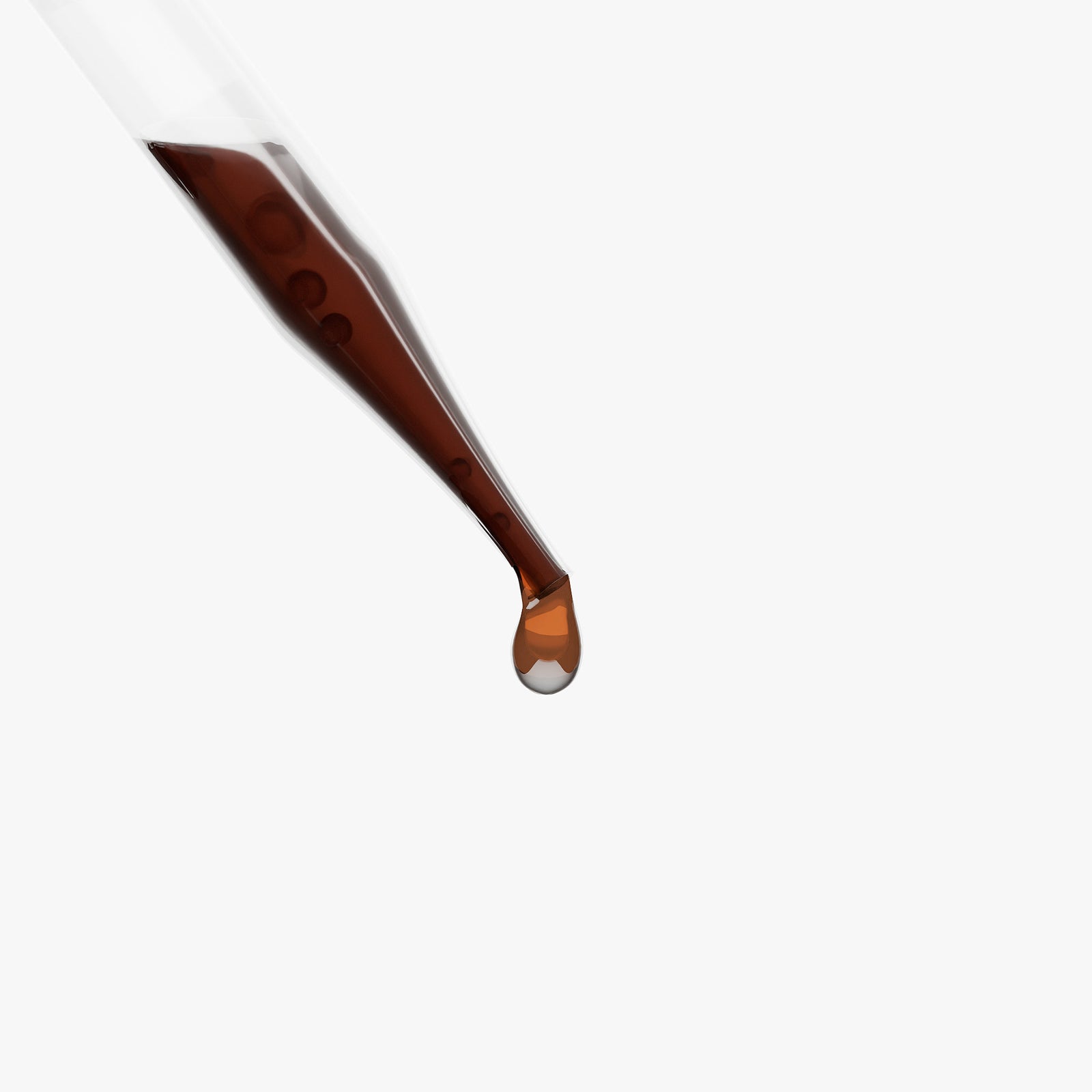 A drop of Mushroom Immune Complex held at the tip of a glass dropper